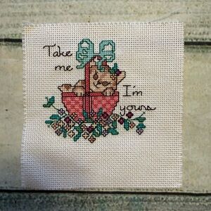 Cute little Grandmacore needlework cat kitten in a basket.